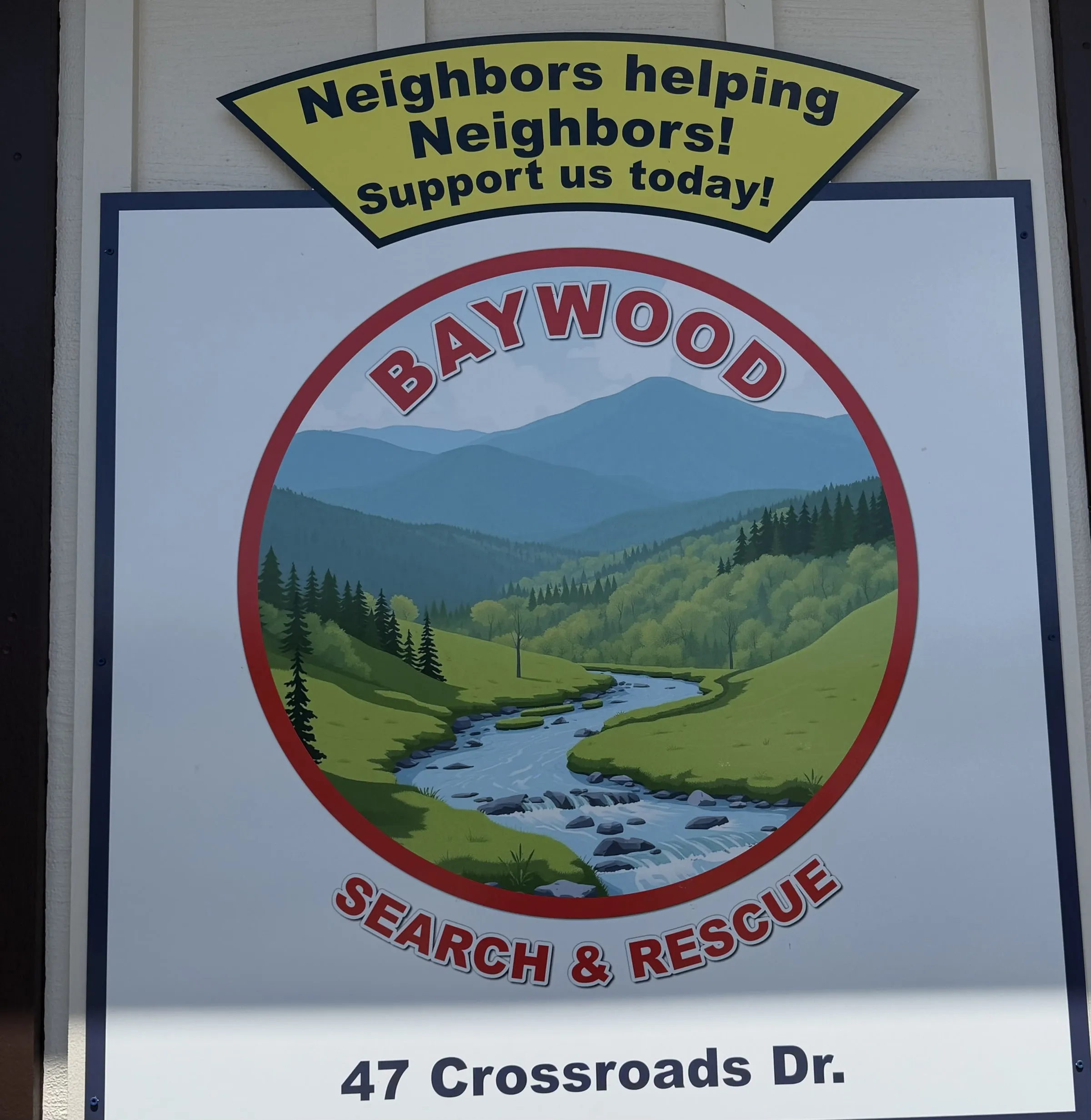 Building-mounted Baywood Search & Rescue sign with the Neighbors Helping Neighbors banner and squad address